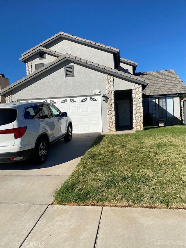 view of front of house with a front yard and a garage