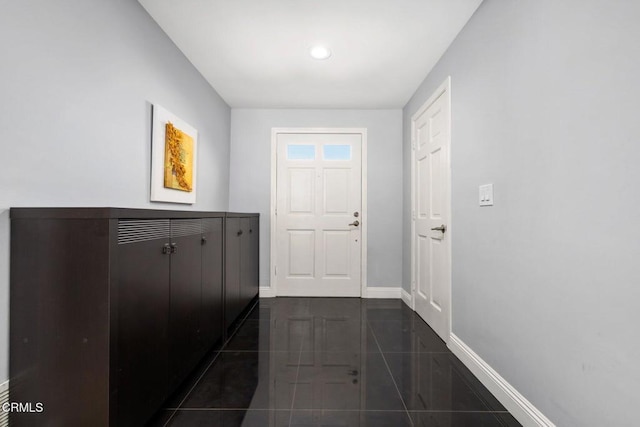 doorway to outside featuring dark tile patterned floors