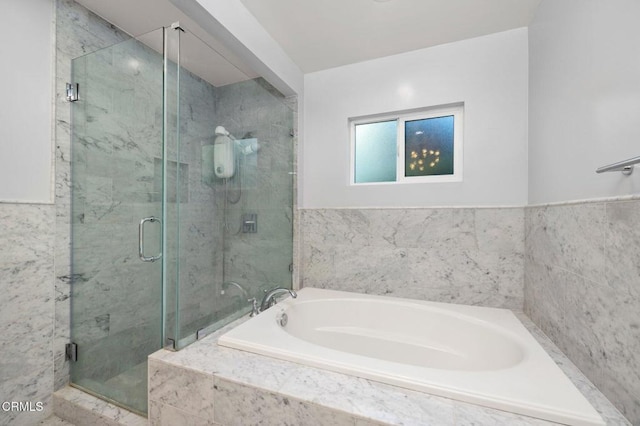 bathroom featuring separate shower and tub