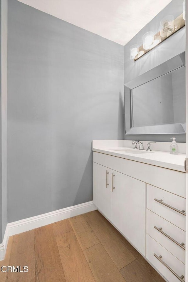 bathroom featuring vanity and hardwood / wood-style flooring