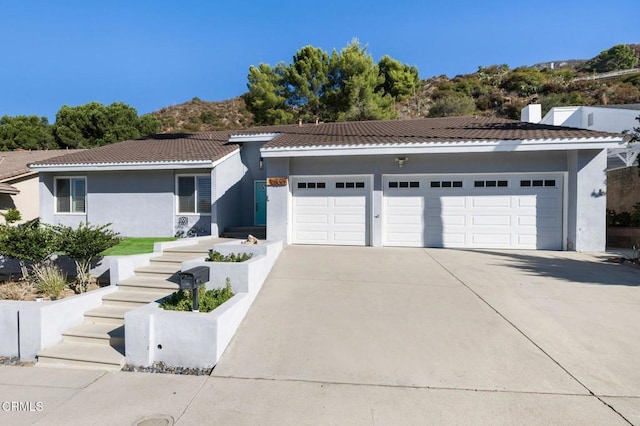 view of front facade with a mountain view and a garage