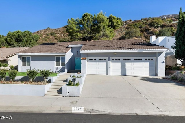 view of front facade with a mountain view and a garage