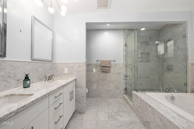 bathroom with shower with separate bathtub and vanity