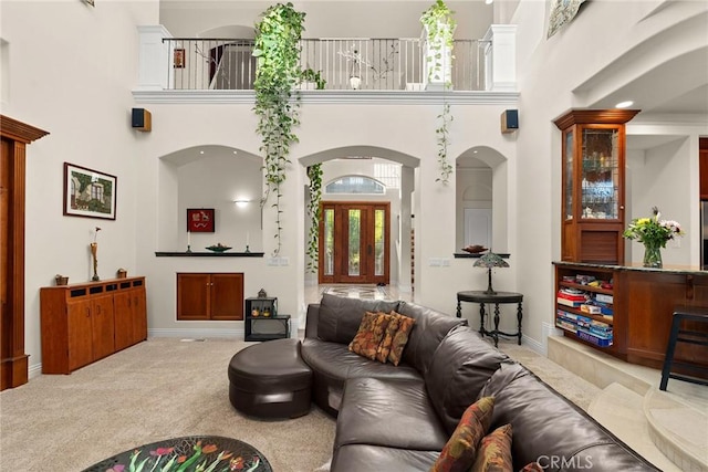 living room with light carpet and a high ceiling