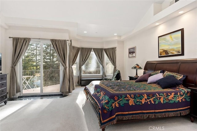 bedroom featuring access to outside, a towering ceiling, and carpet flooring