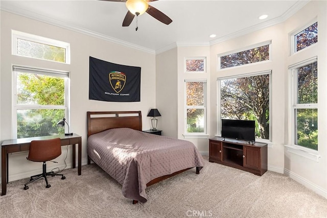 carpeted bedroom with ceiling fan and ornamental molding