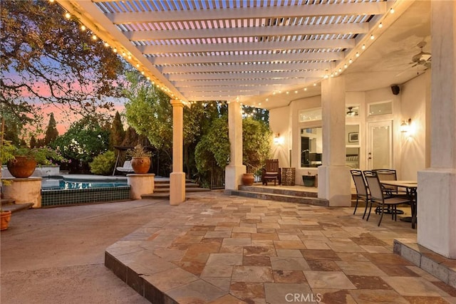 patio terrace at dusk with a pergola and a swimming pool