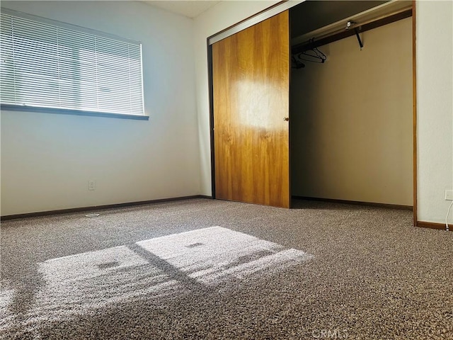 unfurnished bedroom featuring carpet and a closet