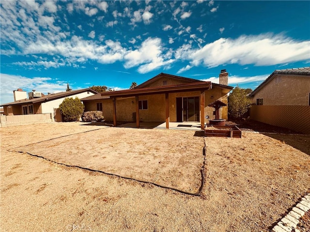 rear view of property featuring a patio area