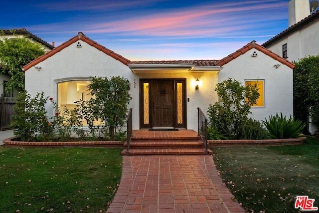 mediterranean / spanish-style house featuring a yard