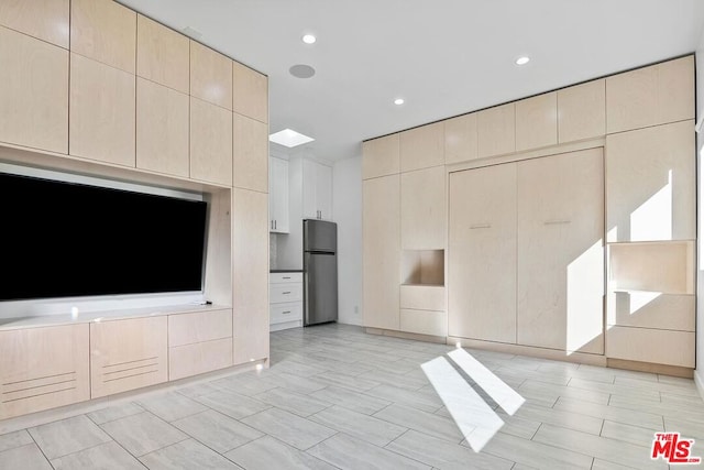 unfurnished living room featuring light wood-type flooring