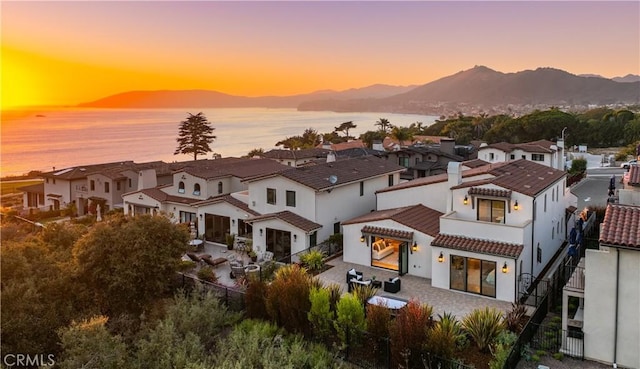 exterior space featuring a residential view and a water and mountain view