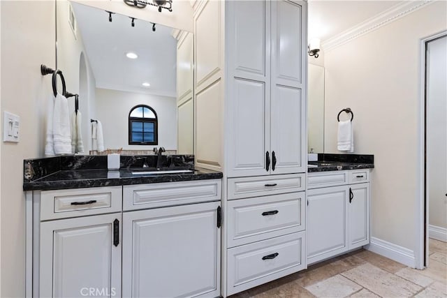 bathroom featuring crown molding and vanity