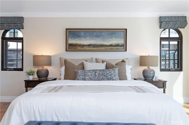 bedroom featuring hardwood / wood-style floors and ornamental molding