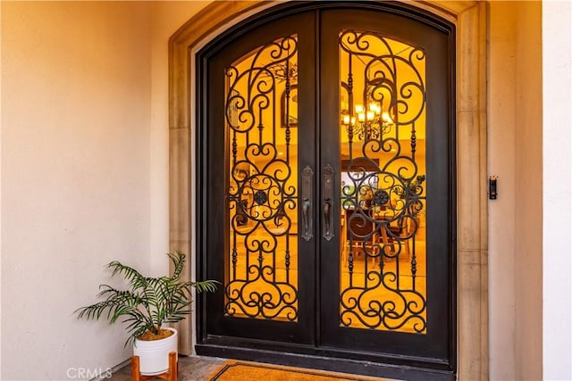 view of exterior entry featuring french doors