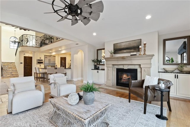 living room with ceiling fan and light hardwood / wood-style floors