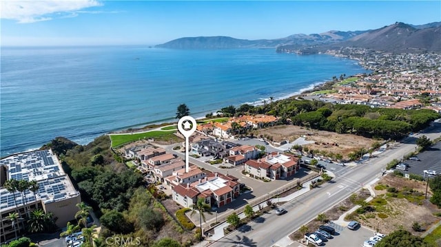 drone / aerial view with a water and mountain view