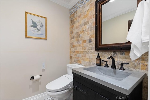 bathroom with crown molding, vanity, and toilet