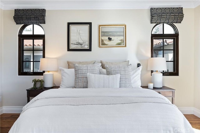 bedroom featuring ornamental molding and dark wood-type flooring