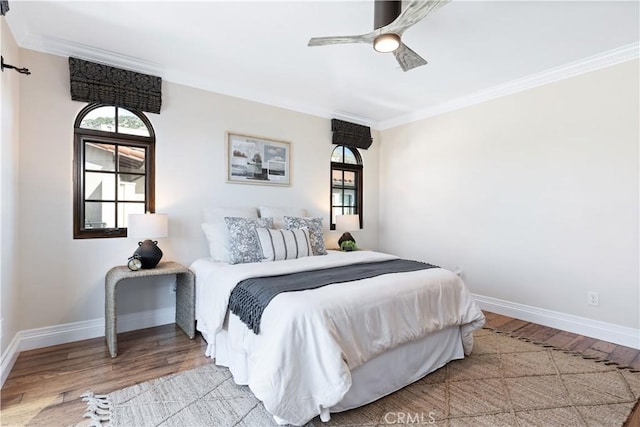 bedroom with crown molding, ceiling fan, and light hardwood / wood-style flooring