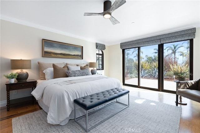 bedroom with light wood finished floors, baseboards, a ceiling fan, ornamental molding, and access to outside