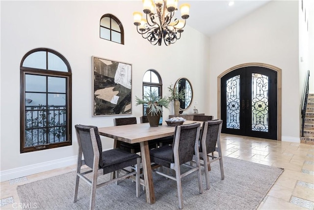 dining room featuring high vaulted ceiling, arched walkways, french doors, and baseboards