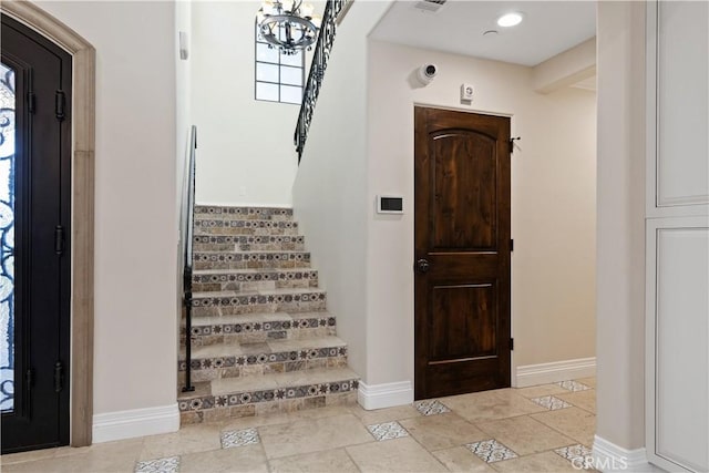 foyer entrance with an inviting chandelier