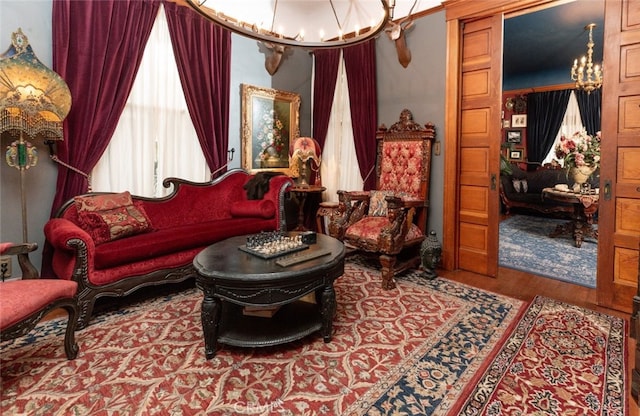 living area featuring hardwood / wood-style floors and a notable chandelier