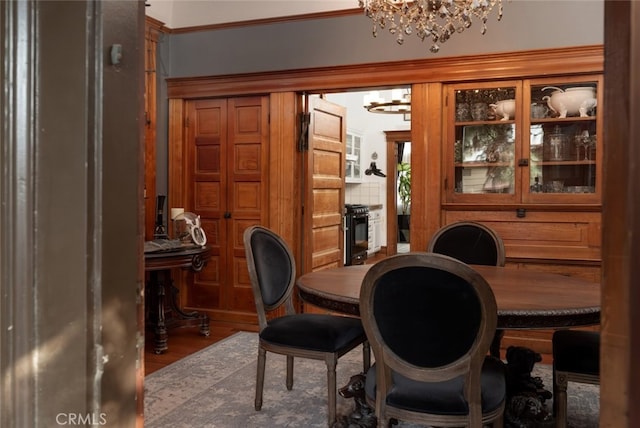 dining area with a notable chandelier and hardwood / wood-style flooring