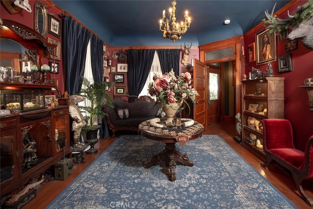 living area featuring hardwood / wood-style floors and an inviting chandelier