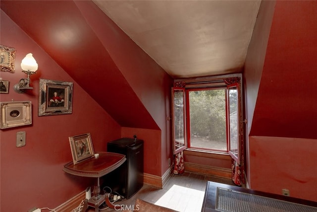 additional living space featuring hardwood / wood-style flooring and lofted ceiling