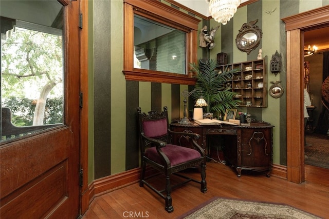 living area featuring a chandelier and wood-type flooring