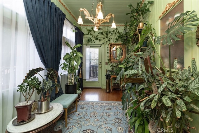 foyer entrance featuring hardwood / wood-style floors and a notable chandelier