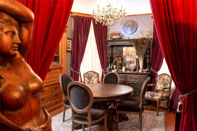 dining space featuring a chandelier, hardwood / wood-style floors, and crown molding