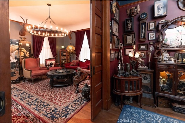 sitting room featuring hardwood / wood-style floors and a chandelier