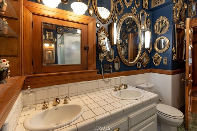 bathroom with decorative backsplash, vanity, and toilet