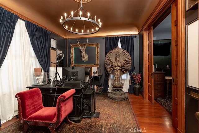 sitting room featuring hardwood / wood-style flooring and a chandelier