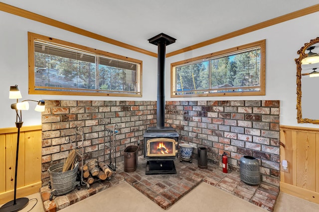 details featuring a wood stove, ornamental molding, wooden walls, and carpet flooring