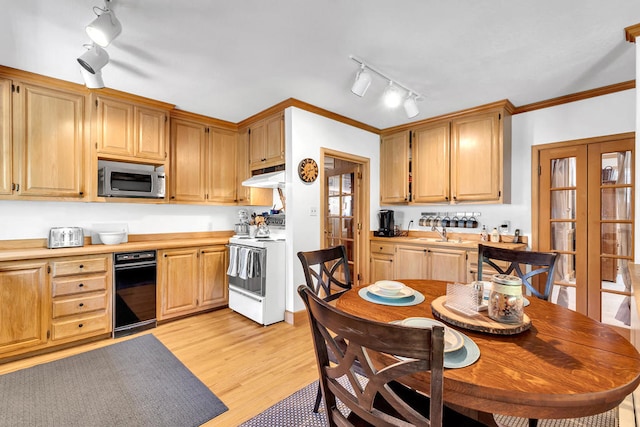 kitchen with light brown cabinets, track lighting, electric range, ornamental molding, and light hardwood / wood-style floors