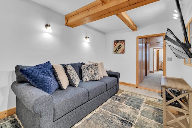 carpeted living room featuring beamed ceiling