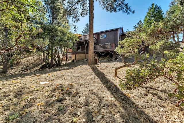 back of house with a wooden deck