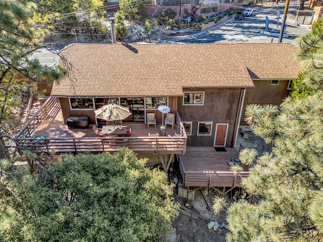 rear view of property featuring a wooden deck