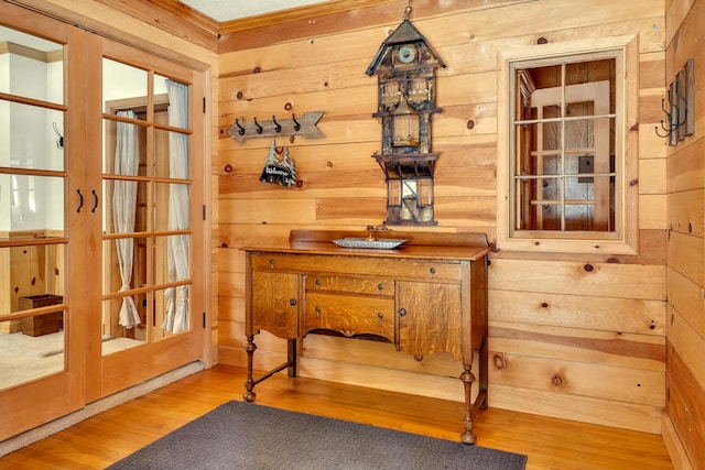 details with hardwood / wood-style floors, french doors, and wooden walls