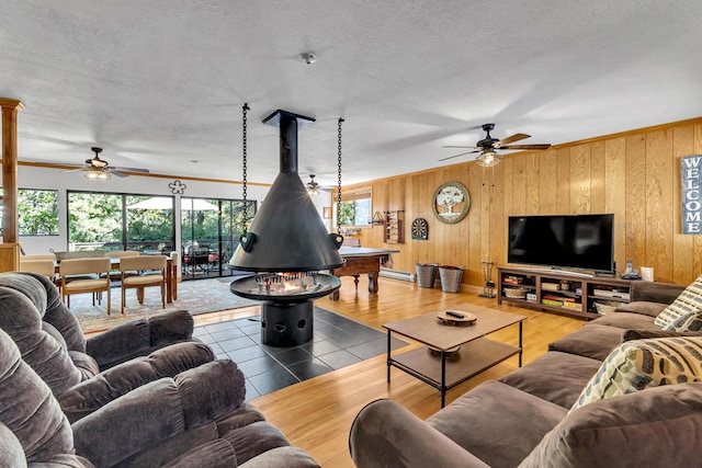 living room with wood-type flooring, a healthy amount of sunlight, and ceiling fan