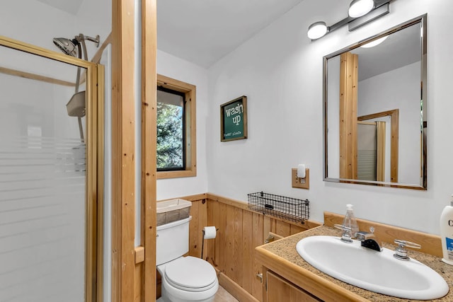 bathroom featuring vanity, toilet, and an enclosed shower