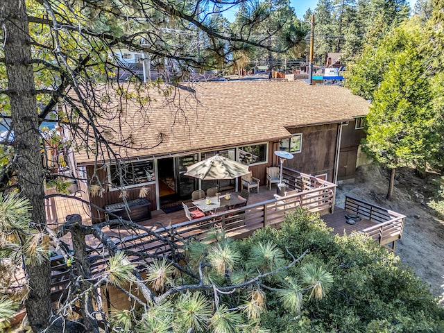 back of property featuring a wooden deck and an outdoor living space