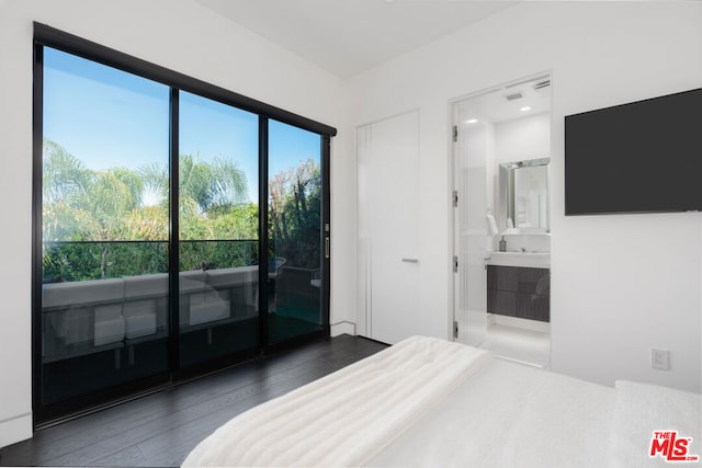 bedroom featuring dark hardwood / wood-style floors and connected bathroom