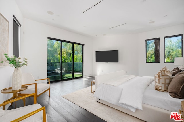 bedroom with hardwood / wood-style floors and access to exterior