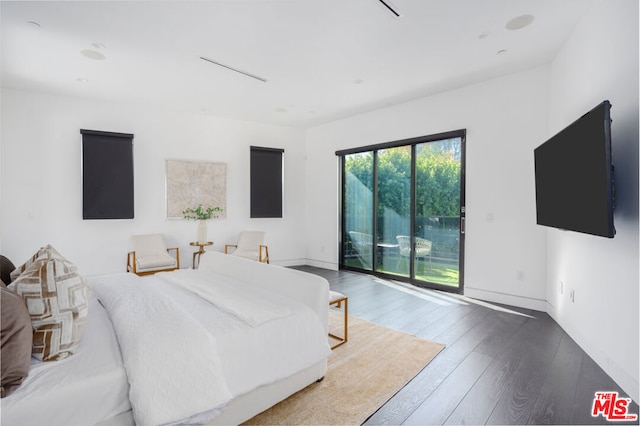 bedroom with access to exterior and hardwood / wood-style flooring