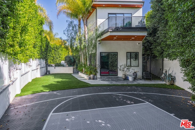 view of basketball court with a lawn